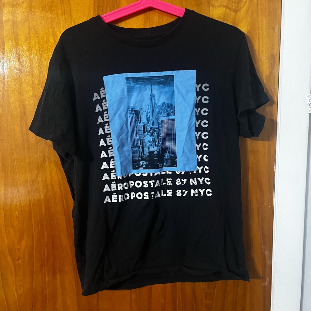 Black t -shirt with blue and white image on front
